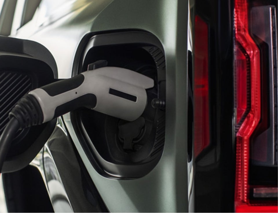 Close up of charging port with charger plugged in on a GMC Hummer EV SUV - Buick GMC of Bellevue in Bellevue WA