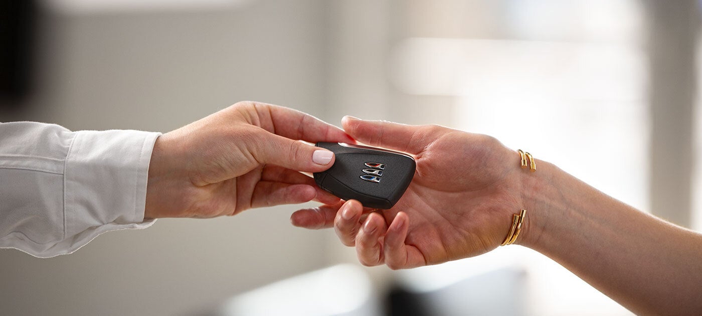 car salesman padding off keys to customers